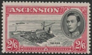 1944 Ascension SG.45c 2/6d black & deep carmine. perf 13 mounted mint.